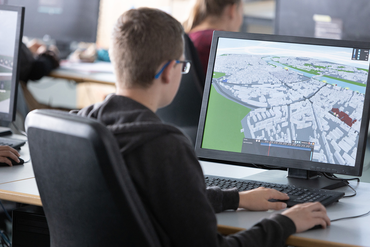 A student is busy with digitalization of a city area by using a software in computer.